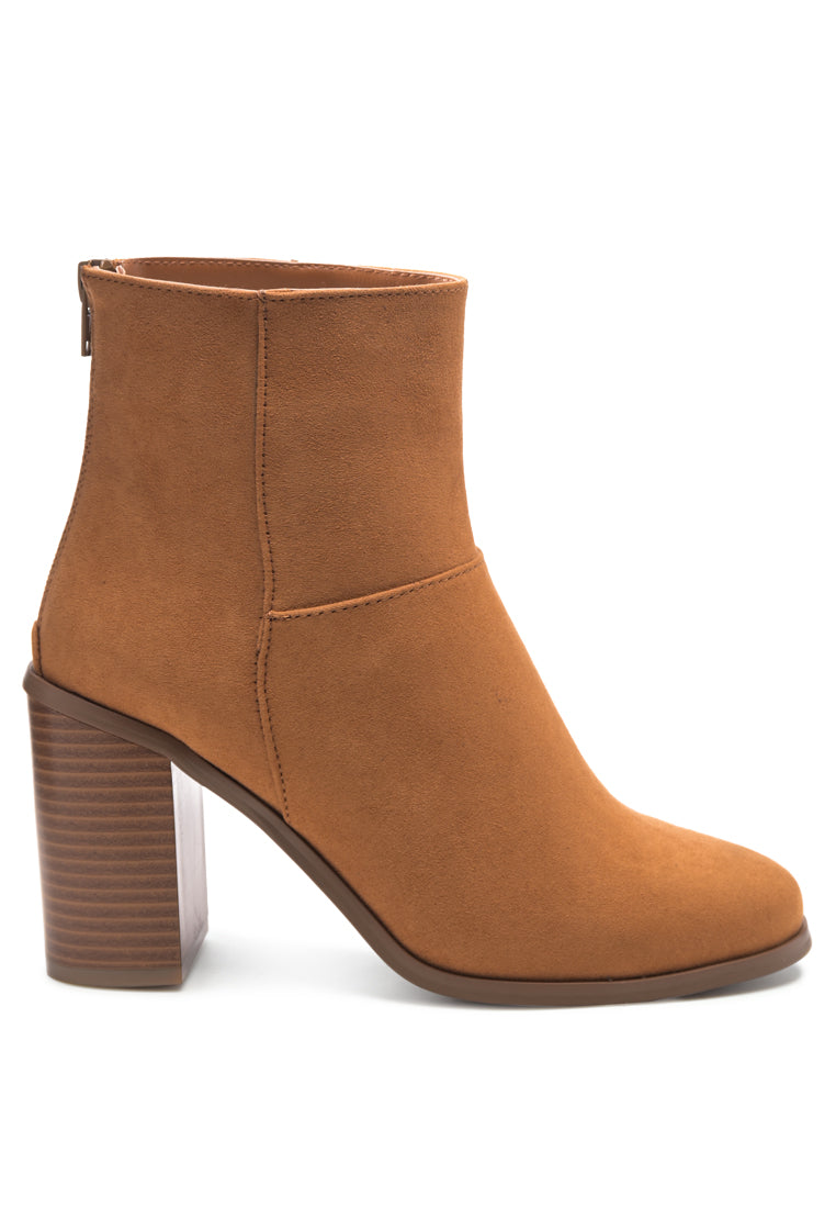 Stylish tan block heeled ankle boots with a back zipper and round toe design, featuring a sturdy stacked pattern block heel.