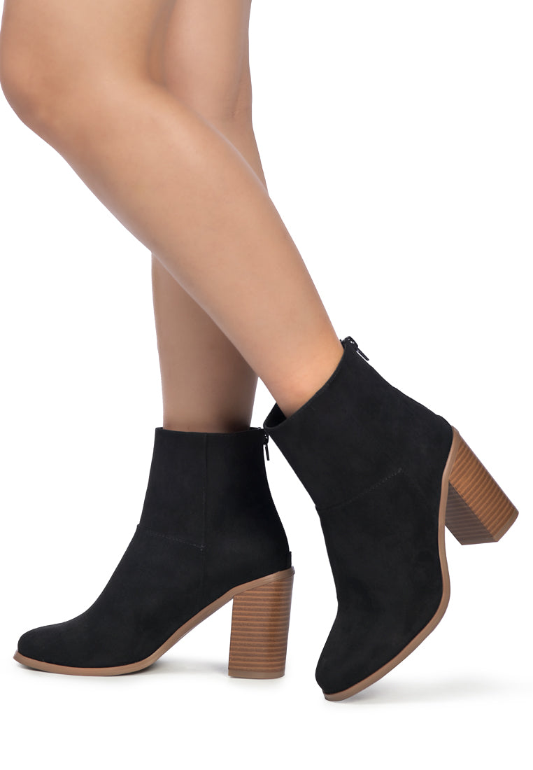 Stylish tan block heeled ankle boots with a back zipper and round toe design, featuring a sturdy stacked pattern block heel.