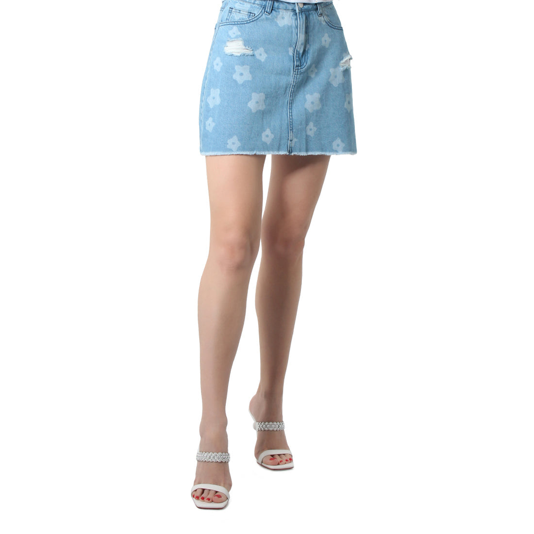 Blue flower print ripped jeans mini skirt with frayed hem and pockets, showcasing a stylish and flirty design.