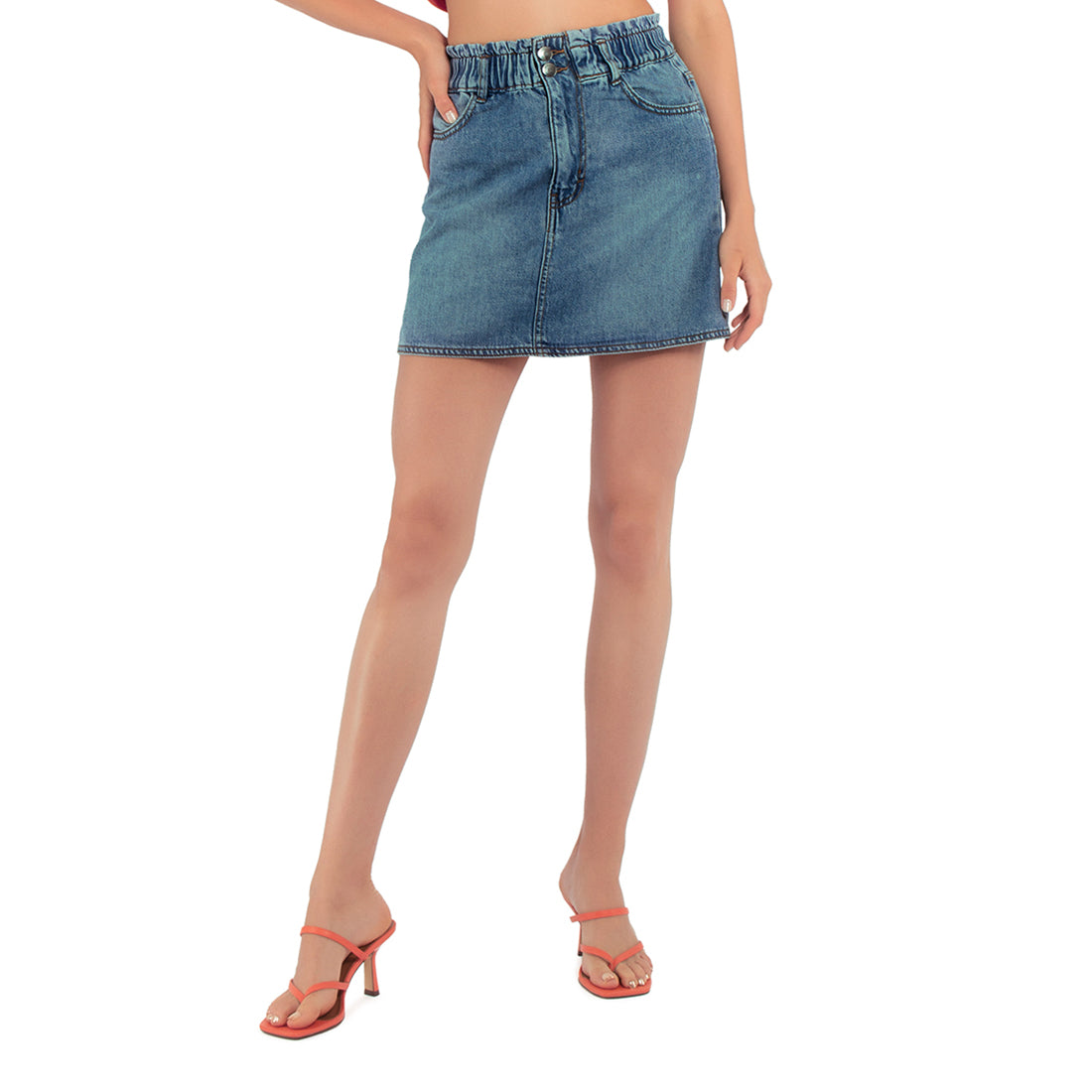 A stylish blue denim skirt featuring a raw hem, mid-rise fit, and multiple pockets, perfect for casual wear.