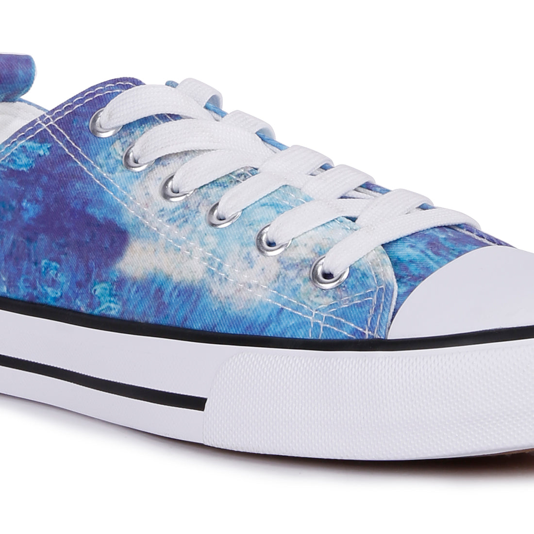 A pair of blue tie dye canvas sneakers with lace-up design and soft cushion innersole, perfect for casual wear.