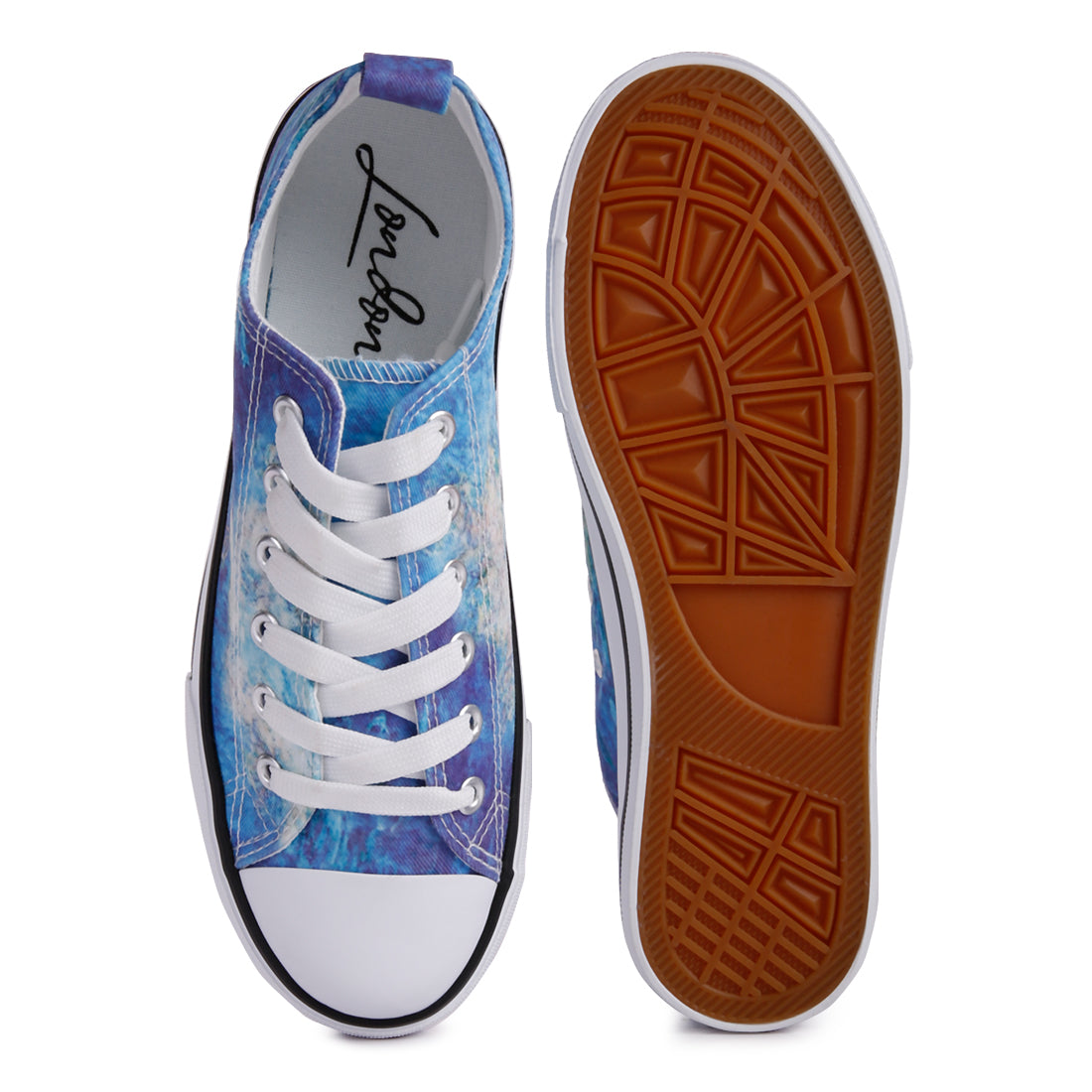 A pair of blue tie dye canvas sneakers with lace-up design and soft cushion innersole, perfect for casual wear.