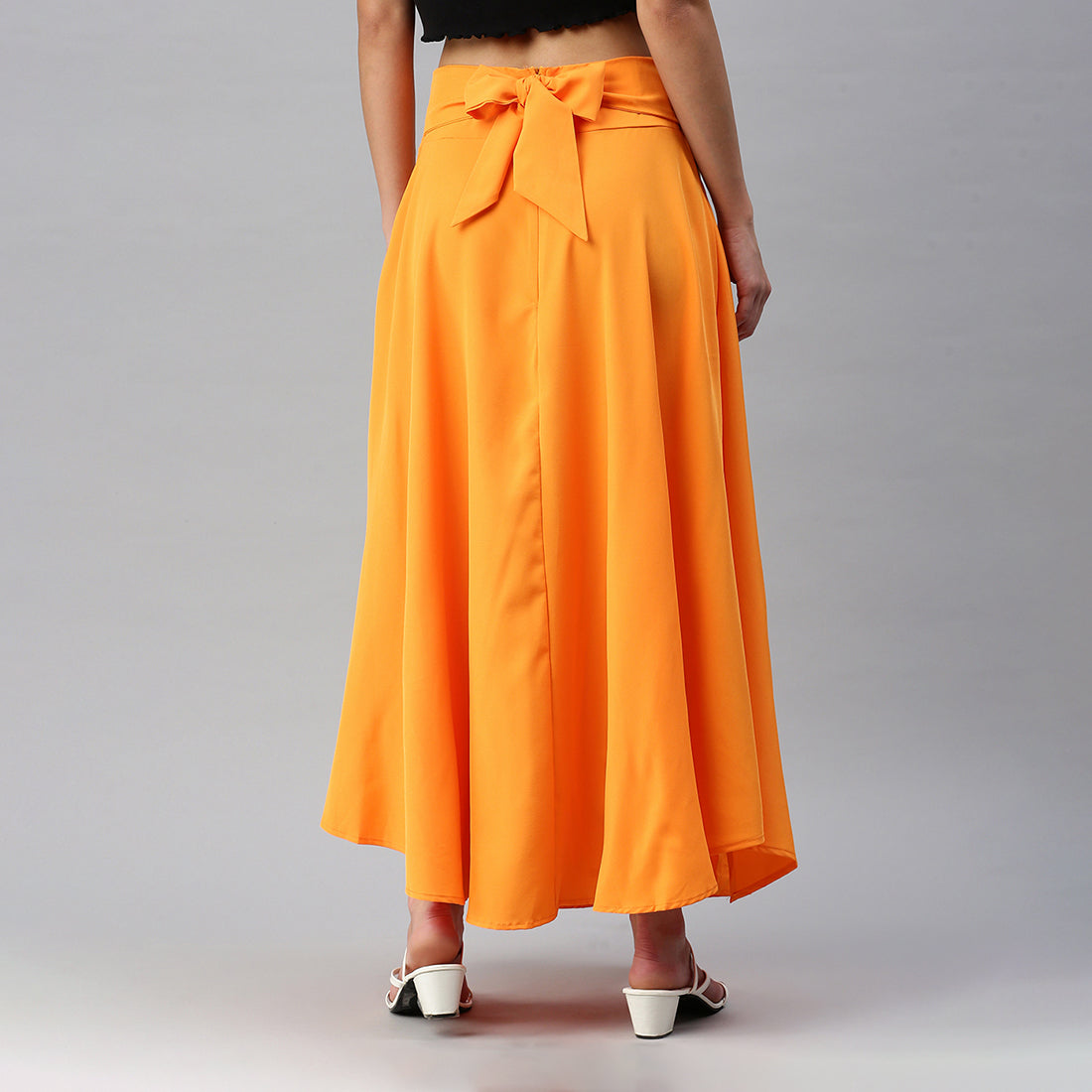 A stylish Bow Detail Slit Long Skirt featuring elegant bows, a mid-rise fit, and a hidden side zipper, perfect for casual and formal occasions.