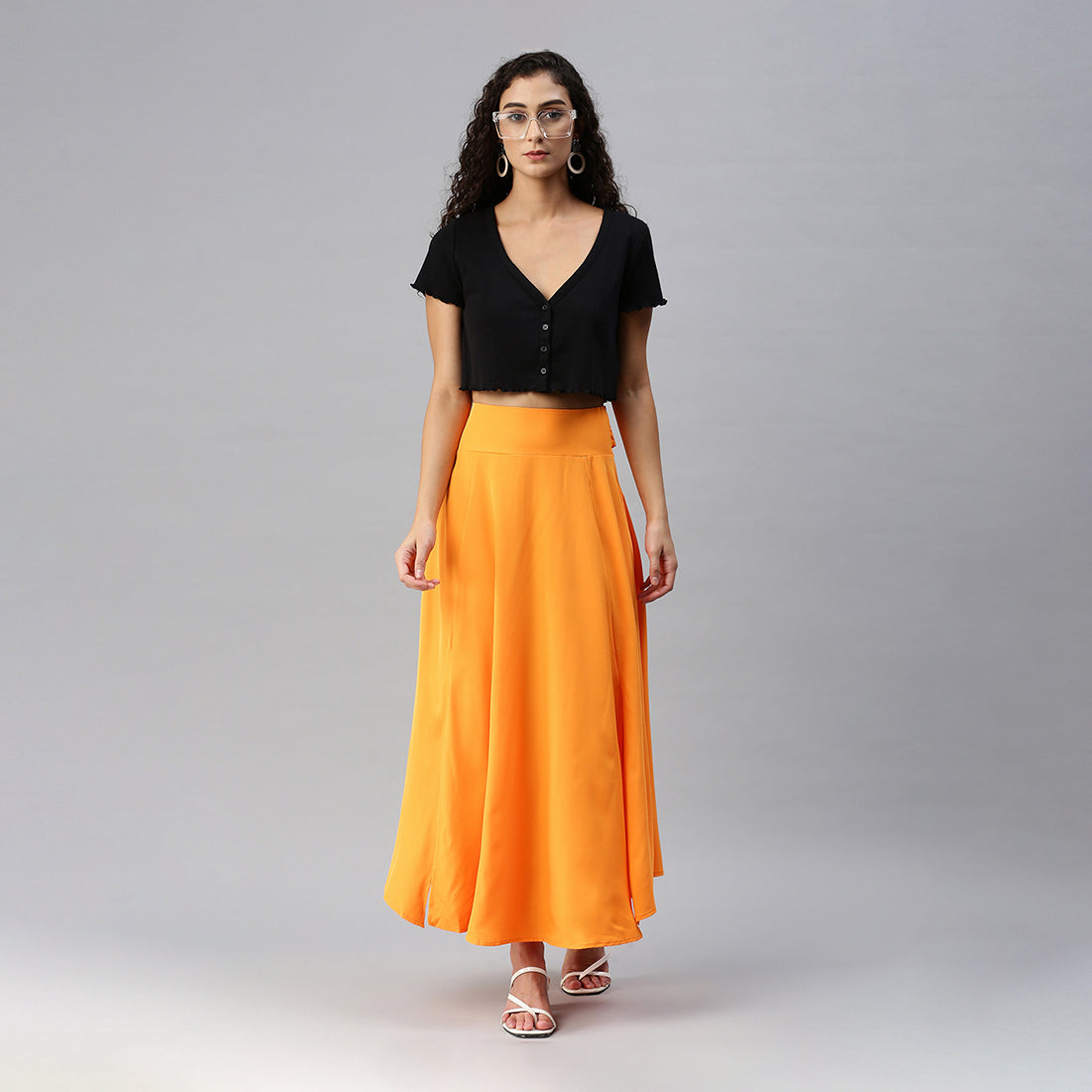 A stylish Bow Detail Slit Long Skirt featuring elegant bows, a mid-rise fit, and a hidden side zipper, perfect for casual and formal occasions.