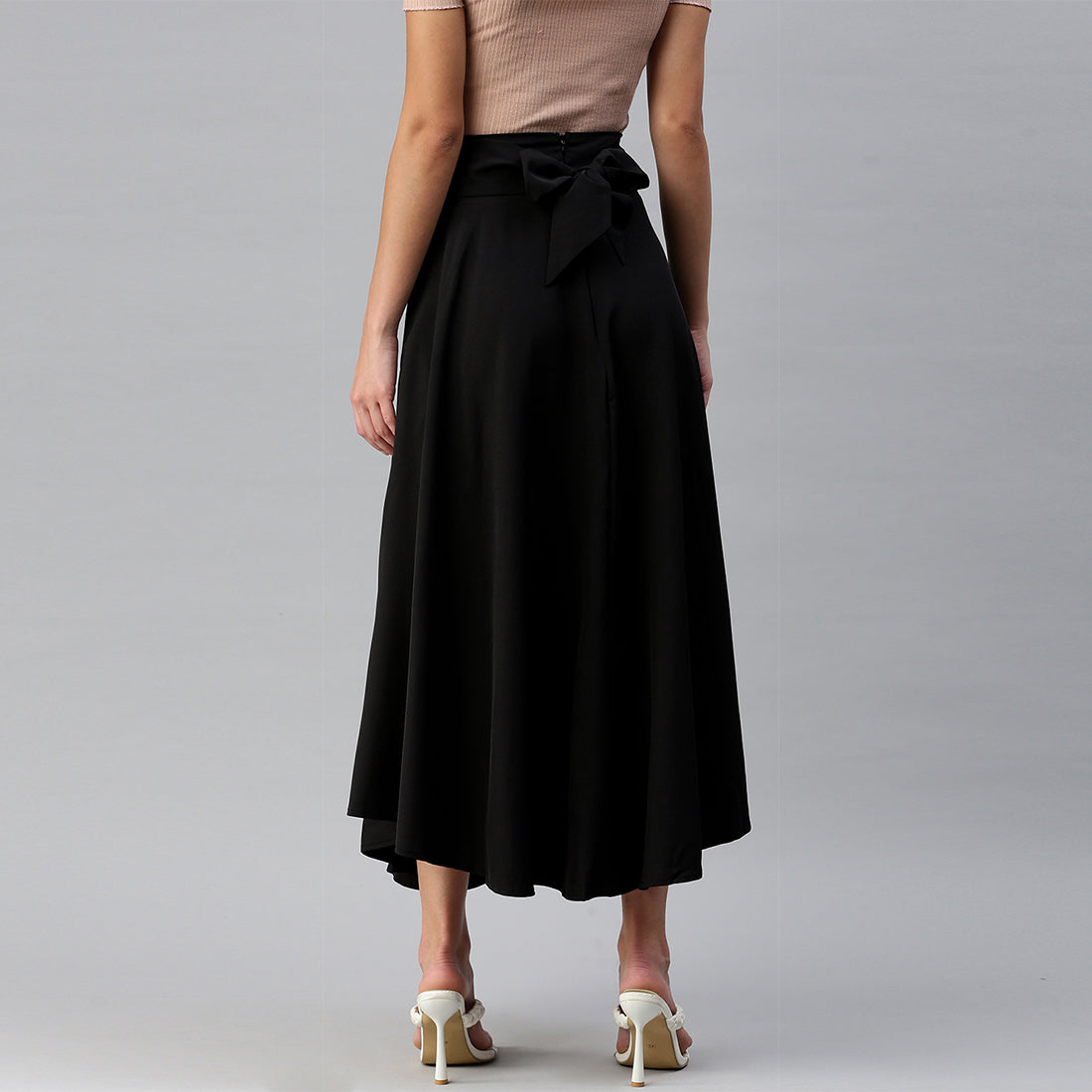 A stylish Bow Detail Slit Long Skirt featuring elegant bows, a mid-rise fit, and a hidden side zipper, perfect for casual and formal occasions.