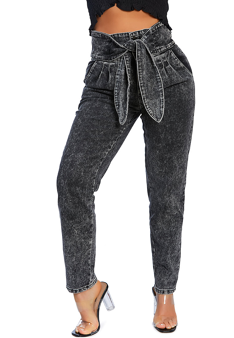 A pair of Bow Together Washed Denim Pants featuring a trendy paper bag waist, relaxed fit, and pleats, displayed on a neutral background.