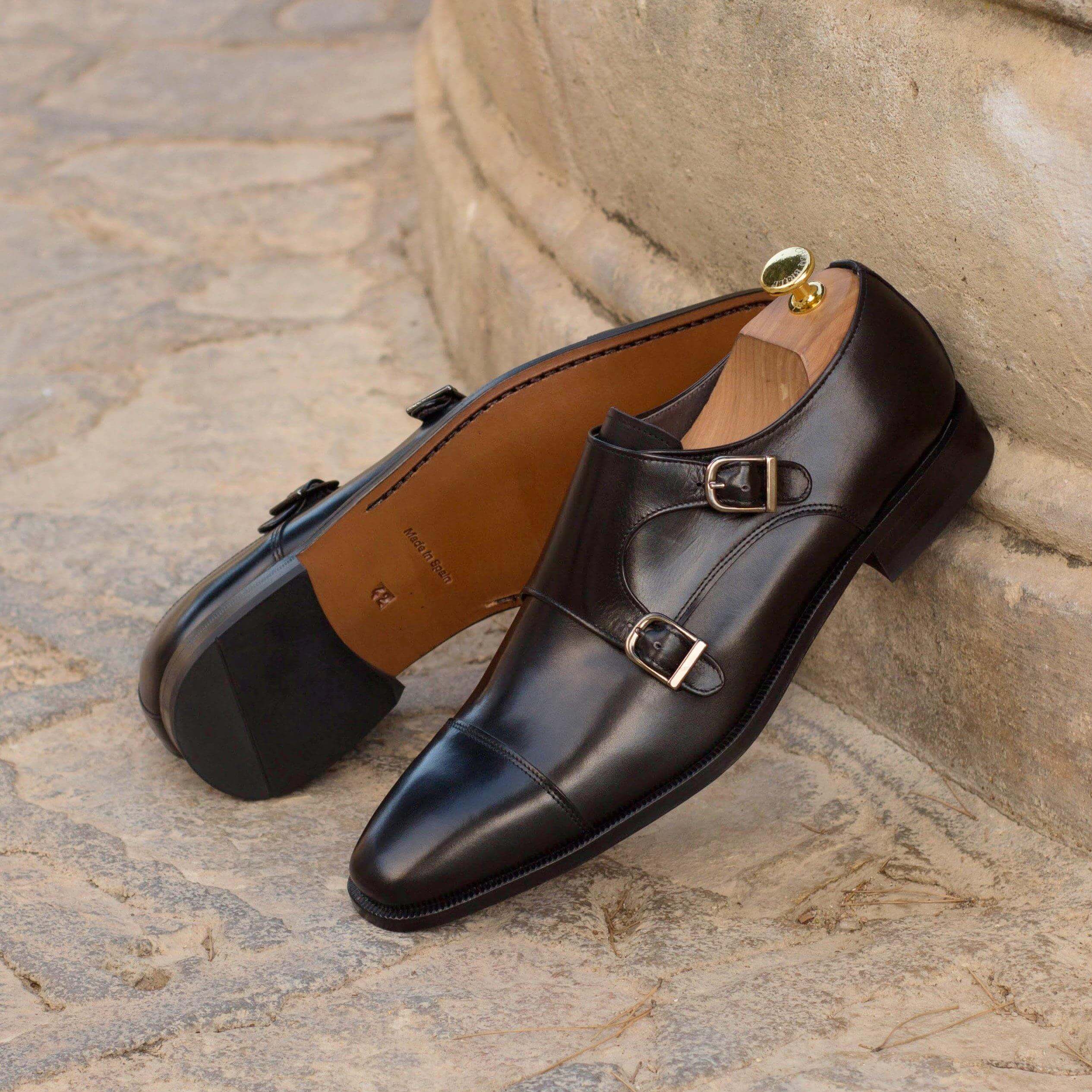 Cayton Double Monk II shoes featuring two elegant straps, crafted from black box calf leather with a cognac leather sole.