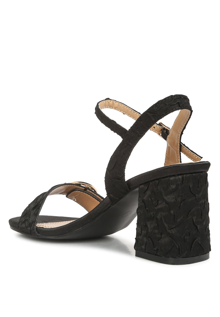 Chaplet Textured Block Heel Sandals featuring a satin upper, block heel, and pin buckle closure, perfect for stylish comfort.