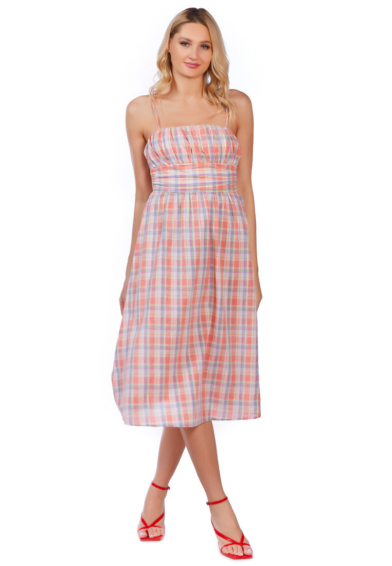 A stylish checkered midi slip dress with tie-up straps and a wrapped waist, made from 100% cotton, perfect for casual outings.