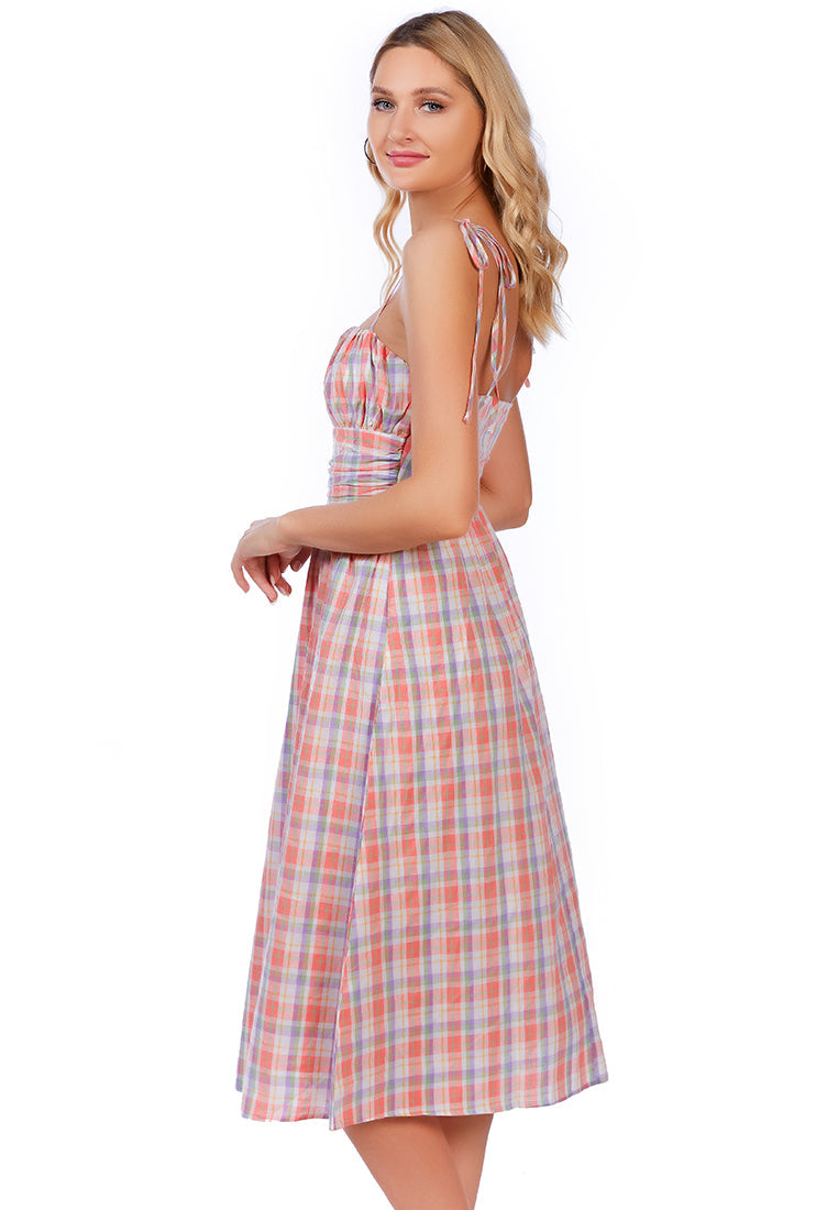 A stylish checkered midi slip dress with tie-up straps and a wrapped waist, made from 100% cotton, perfect for casual outings.