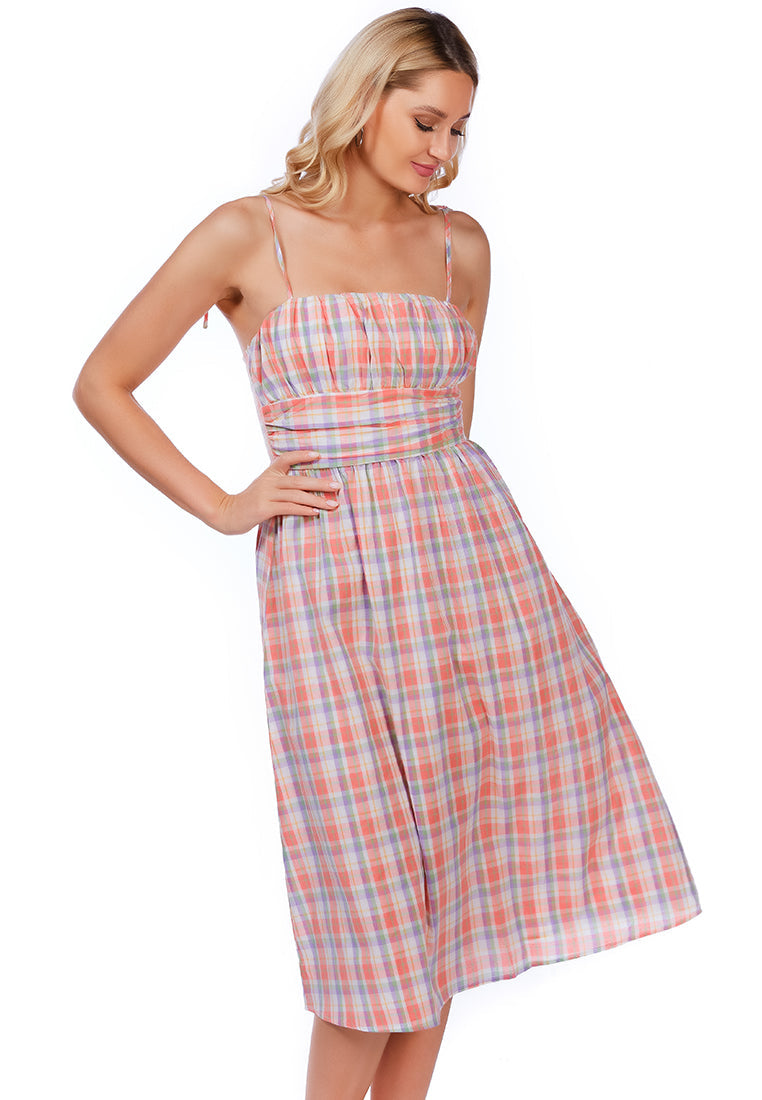 A stylish checkered midi slip dress with tie-up straps and a wrapped waist, made from 100% cotton, perfect for casual outings.