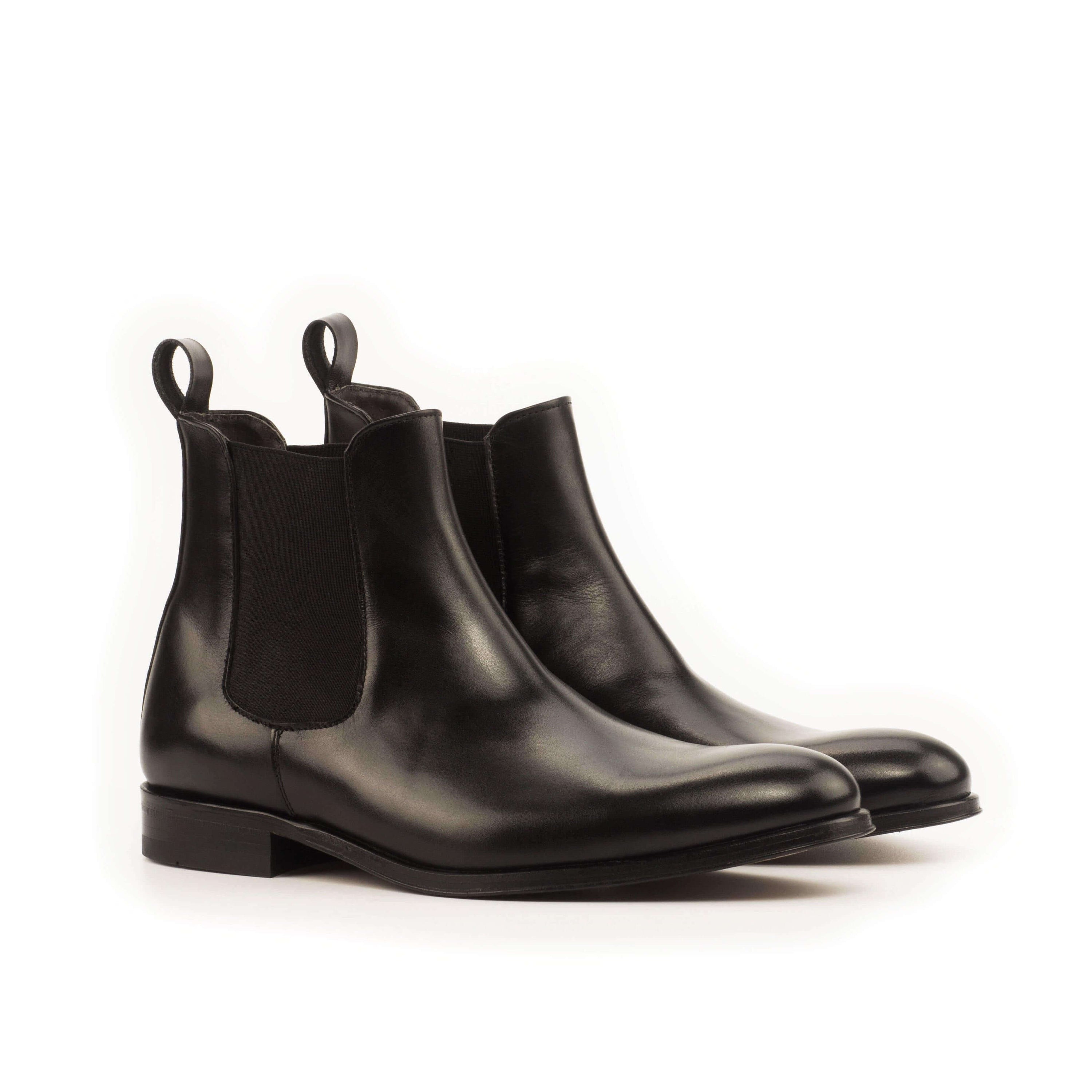 Chumani Chelsea Boots II in black box calf leather with cognac leather sole, showcasing a rounded toe design.