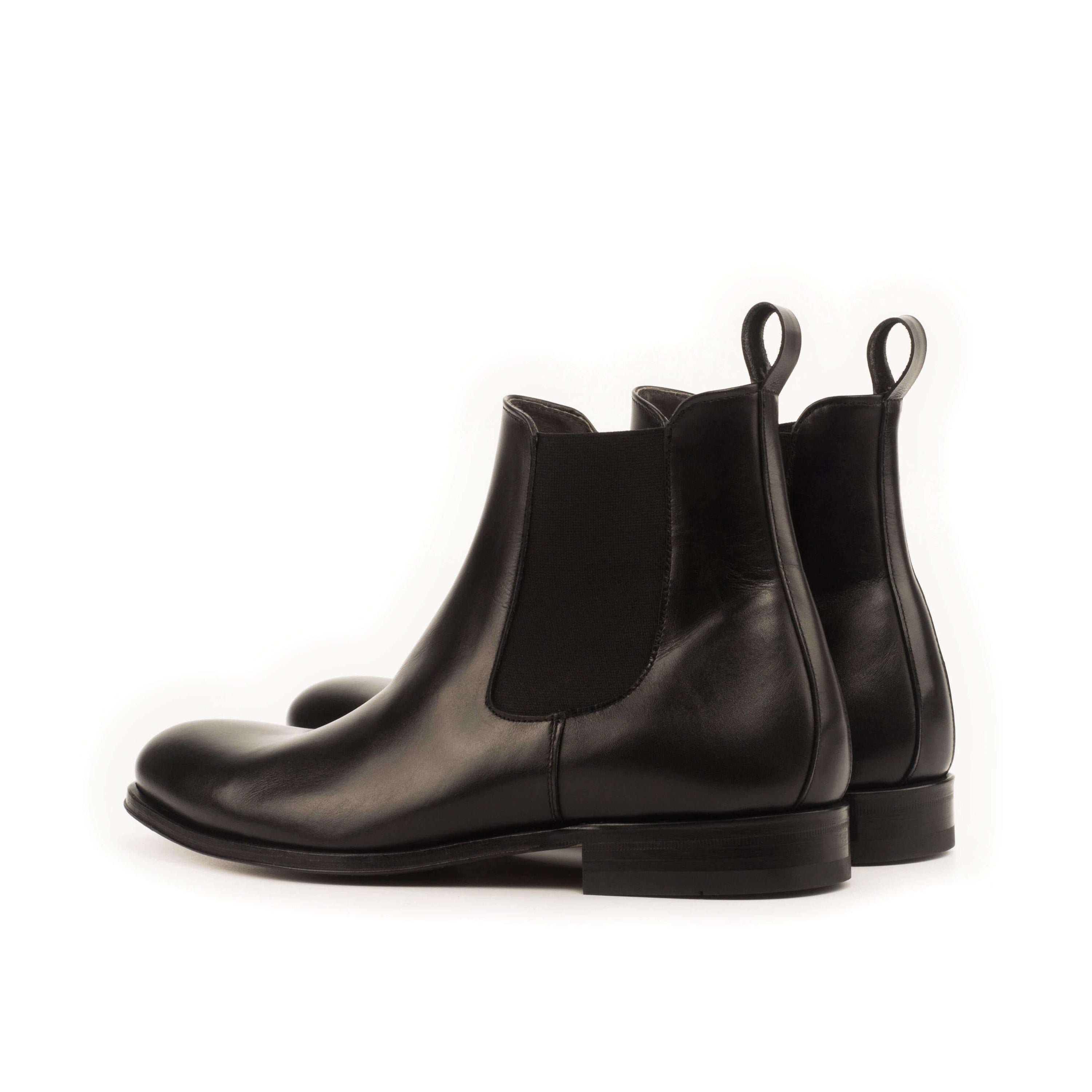 Chumani Chelsea Boots II in black box calf leather with cognac leather sole, showcasing a rounded toe design.