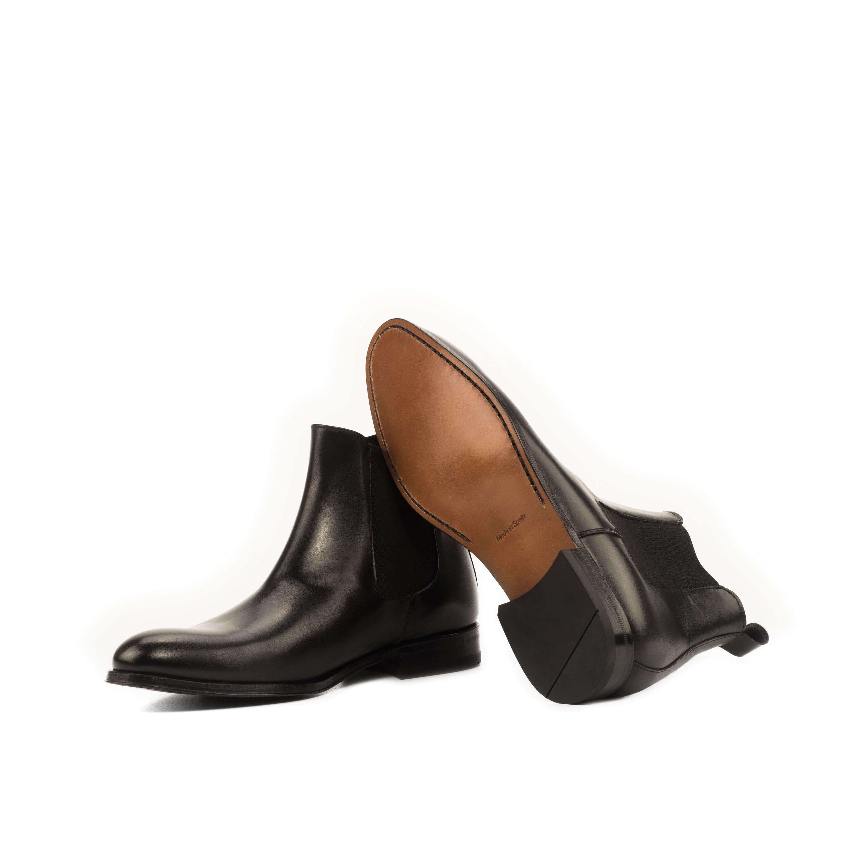 Chumani Chelsea Boots II in black box calf leather with cognac leather sole, showcasing a rounded toe design.