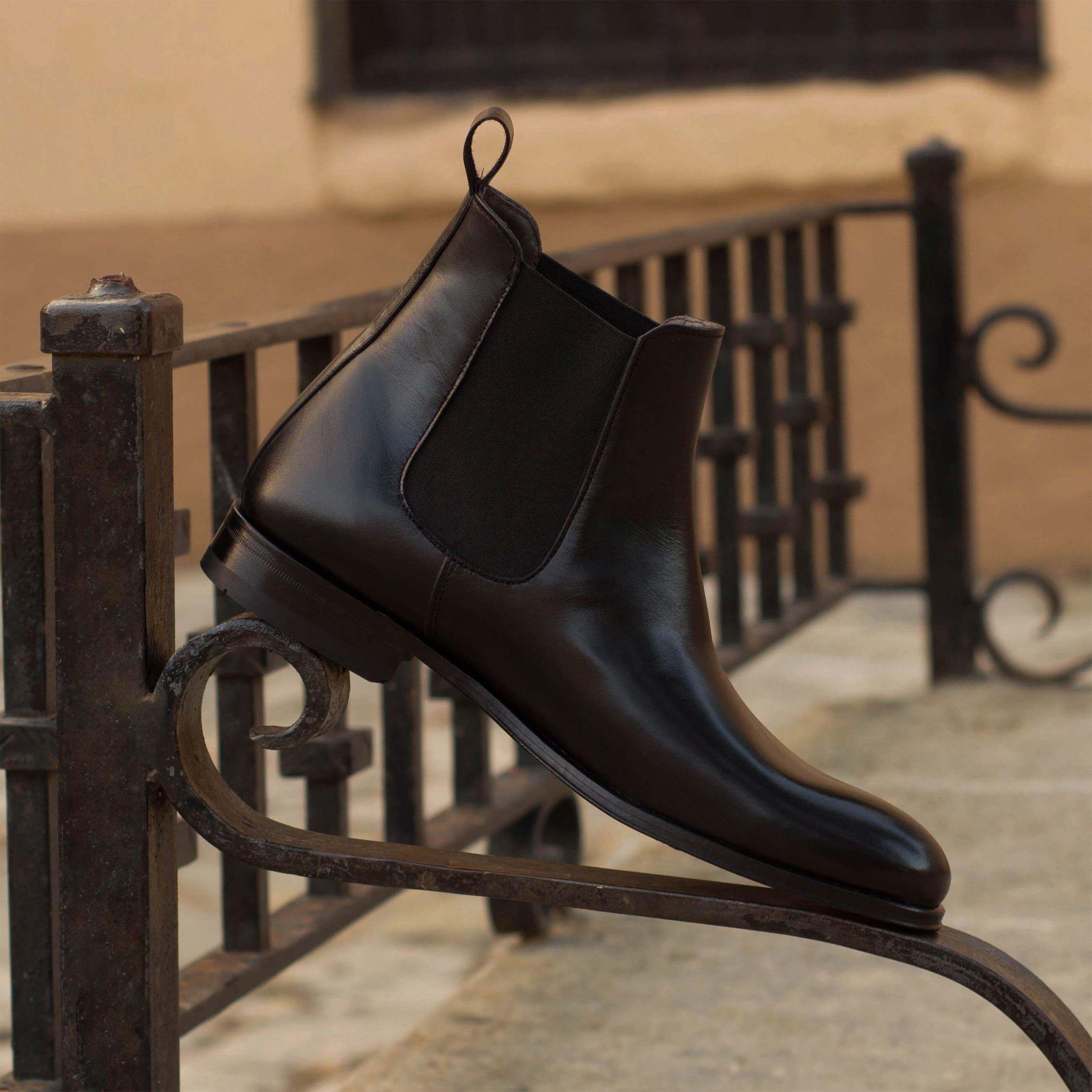 Chumani Chelsea Boots II in black box calf leather with cognac leather sole, showcasing a rounded toe design.