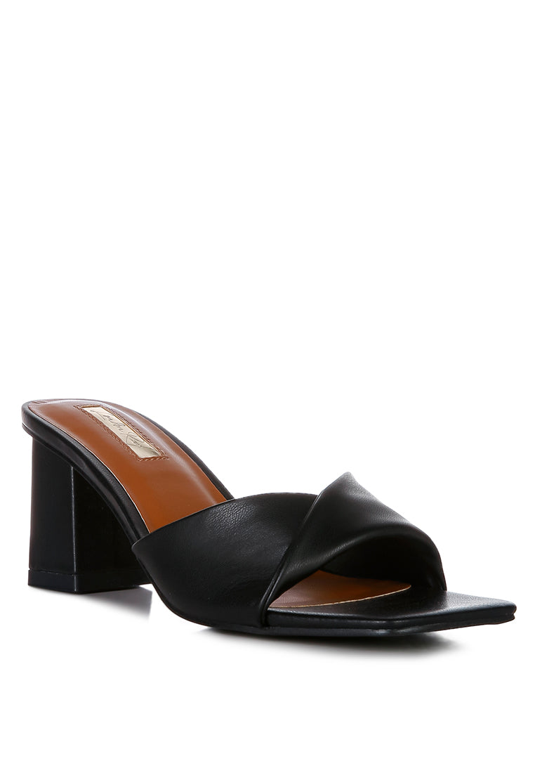 Cityscape Block Heel Slip-On Sandals featuring a stylish faux leather twisted strap and open square toe design.