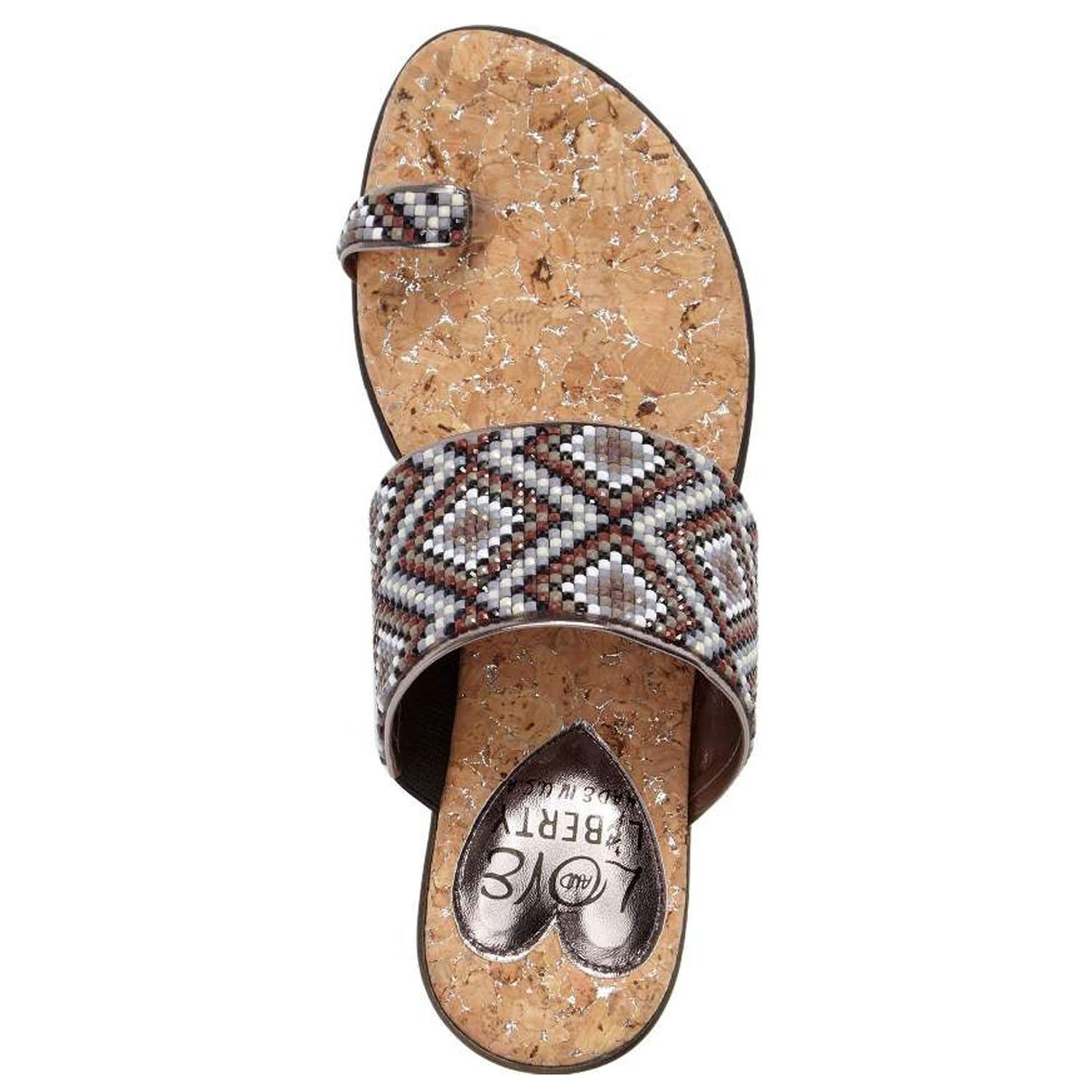 Coastal sandals featuring a diamond patterned leather upper, memory foam padding, and a low wedge outsole, perfect for summer outings.