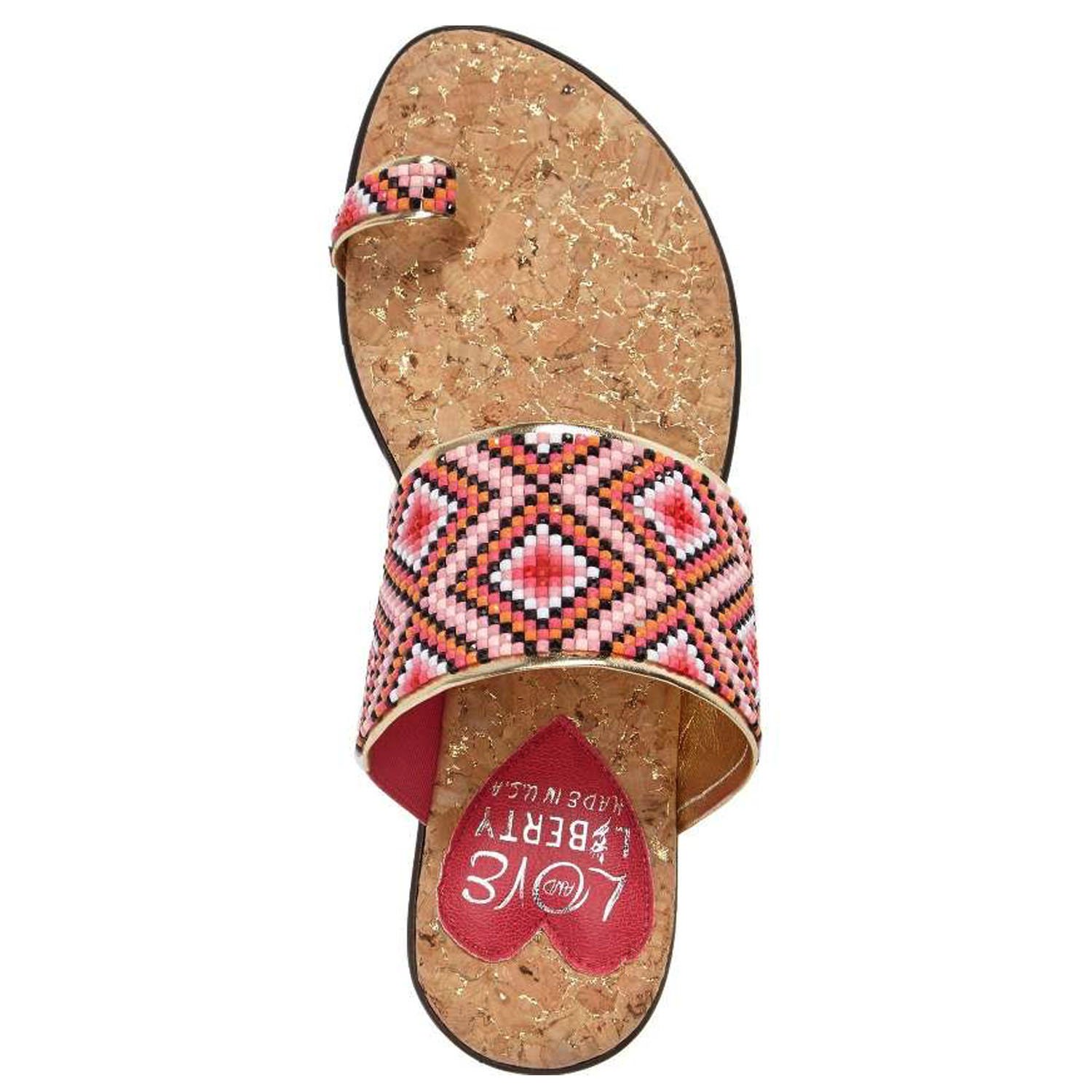 Coastal sandals featuring a diamond patterned leather upper, memory foam padding, and a low wedge outsole, perfect for summer outings.