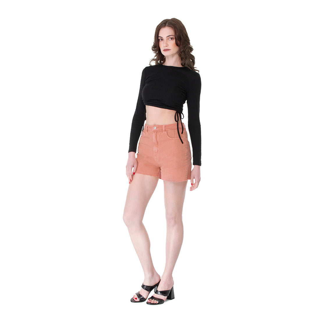 A pair of coral denim shorts with a raw hem, featuring front and back pockets, perfect for summer styling.