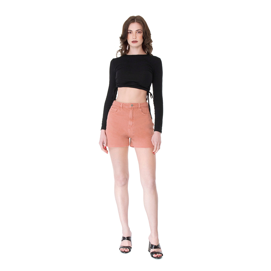 A pair of coral denim shorts with a raw hem, featuring front and back pockets, perfect for summer styling.