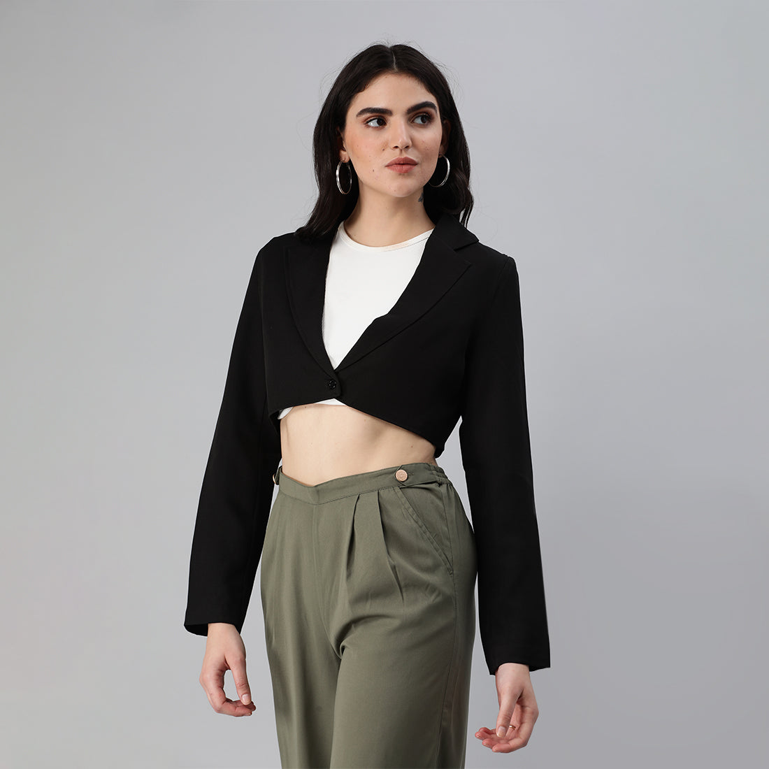 A stylish cropped tailored blazer featuring lapels and button detailing, made from a soft polyester-spandex blend.