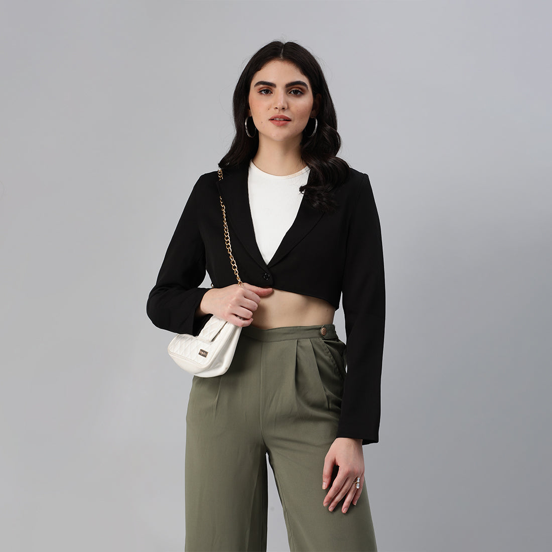 A stylish cropped tailored blazer featuring lapels and button detailing, made from a soft polyester-spandex blend.