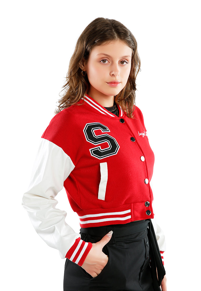 A stylish cropped varsity jacket featuring contrasting slash pockets and stripes, designed for a trendy look.