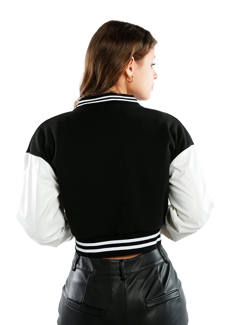 A stylish cropped varsity jacket featuring contrasting slash pockets and stripes, designed for a trendy look.