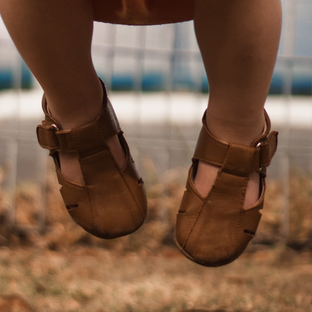 Dakota Baby & Toddler First Walker Shoes in Tan, handcrafted leather with soft suede sole, designed for comfort and support.