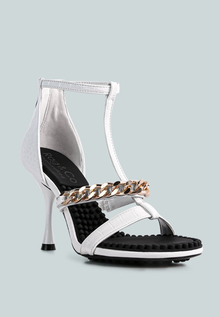 Dakota Metal Chain Mid Heel Sandals featuring a stylish T-strap design with a metal chain detail, available in black, white, and latte colors.