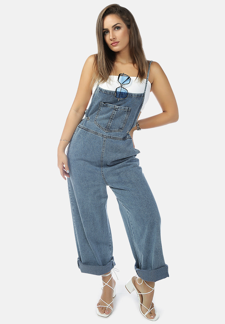 Deep blue denim tie-up spaghetti jumpsuit with front patch pocket and adjustable waist drawstring, perfect for casual outings.