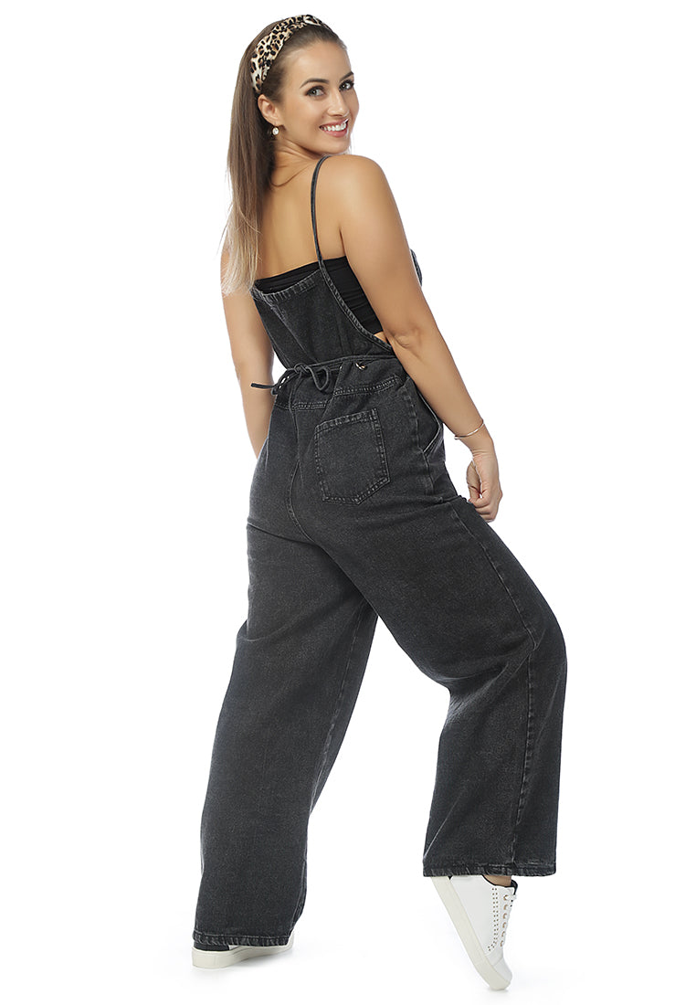 Deep blue denim tie-up spaghetti jumpsuit with front patch pocket and adjustable waist drawstring, perfect for casual outings.