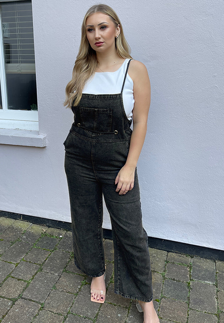 Deep blue denim tie-up spaghetti jumpsuit with front patch pocket and adjustable waist drawstring, perfect for casual outings.