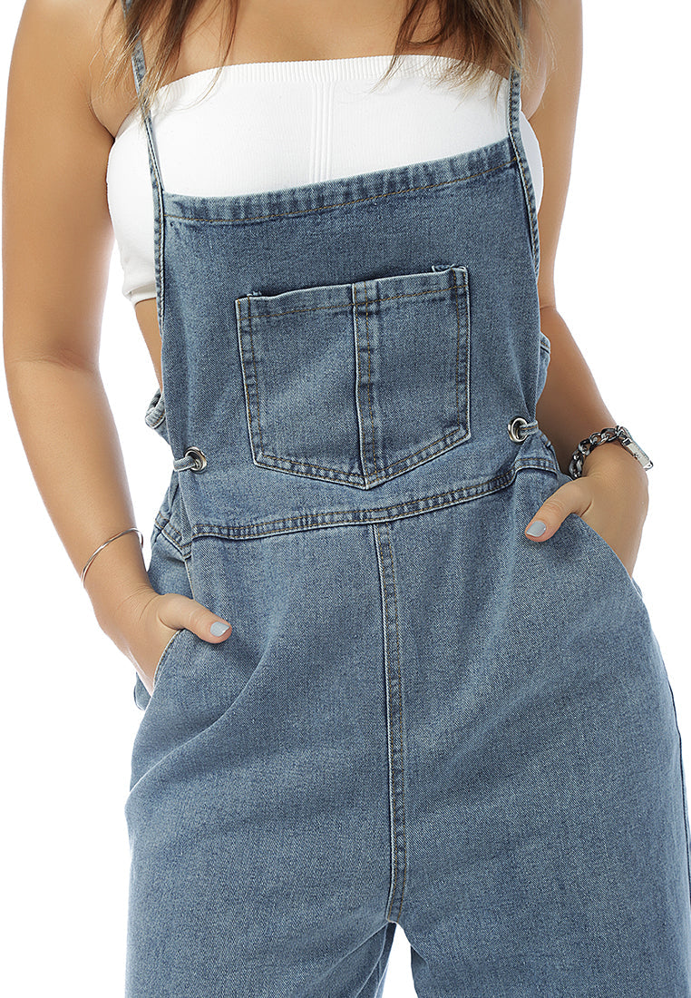 Deep blue denim tie-up spaghetti jumpsuit with front patch pocket and adjustable waist drawstring, perfect for casual outings.