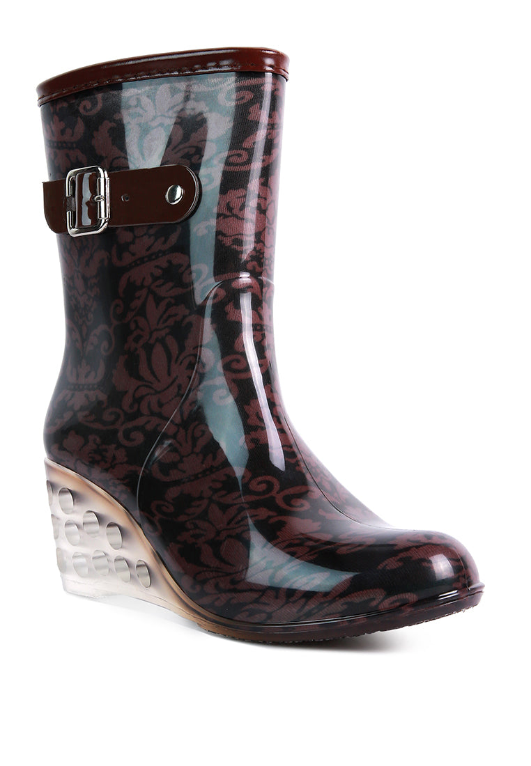 Drench Clear Wedge Rainboots featuring a clear wedge heel, side zipper, and buckle detail, perfect for stylish monsoon wear.