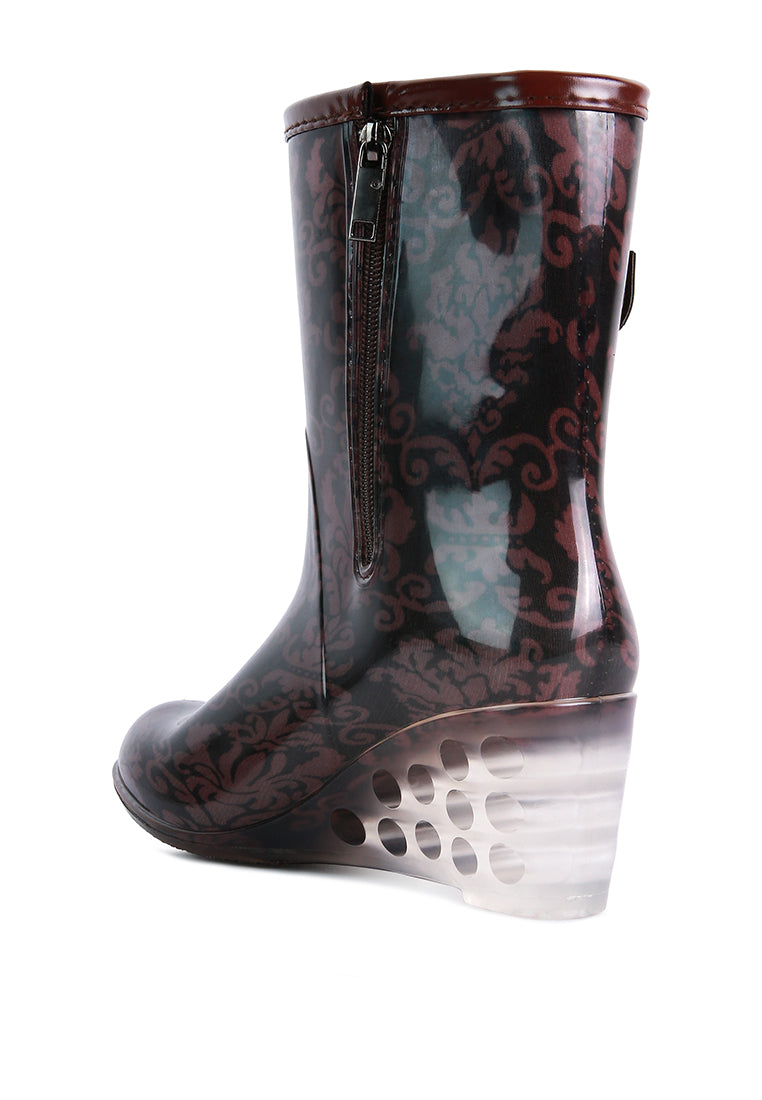 Drench Clear Wedge Rainboots featuring a clear wedge heel, side zipper, and buckle detail, perfect for stylish monsoon wear.