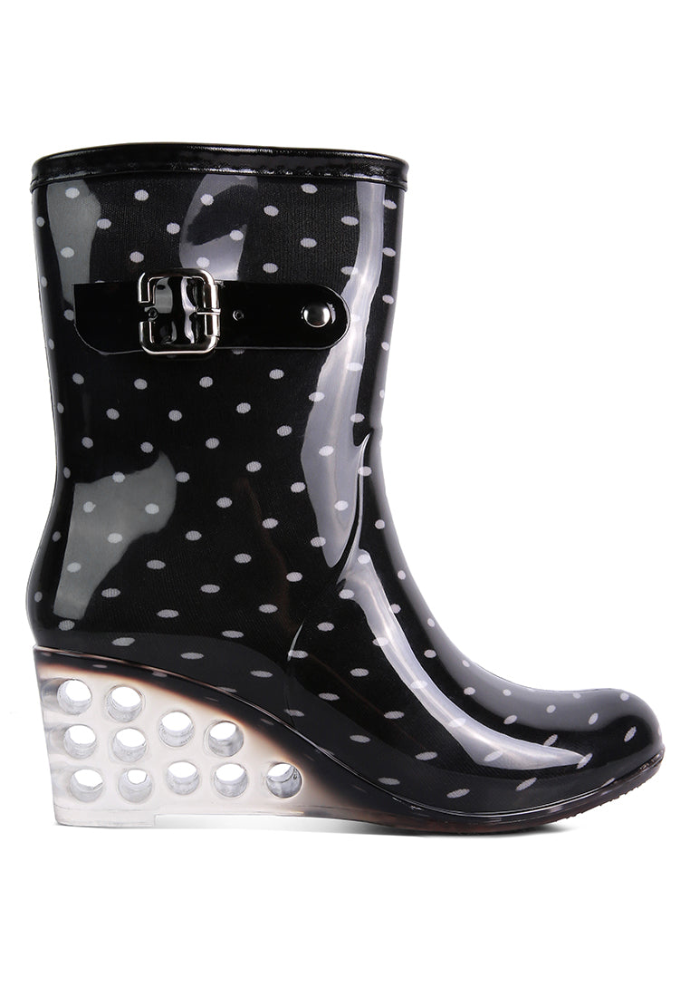 Drench Clear Wedge Rainboots featuring a clear wedge heel, side zipper, and buckle detail, perfect for stylish monsoon wear.