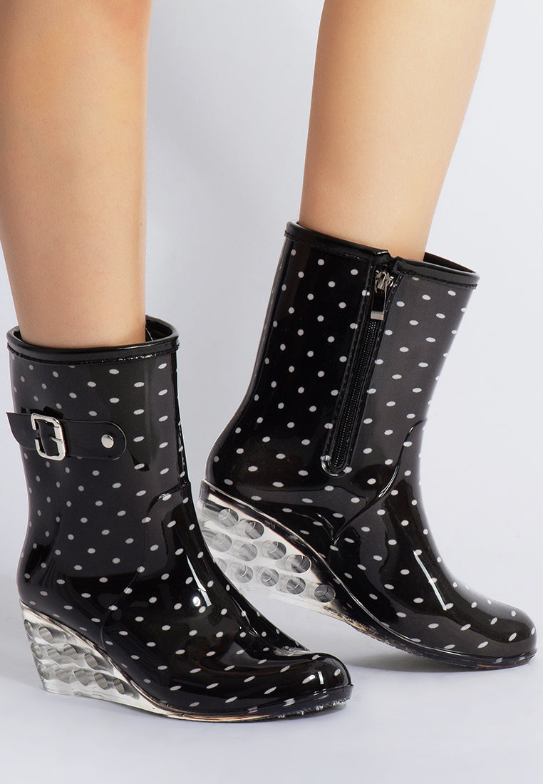 Drench Clear Wedge Rainboots featuring a clear wedge heel, side zipper, and buckle detail, perfect for stylish monsoon wear.