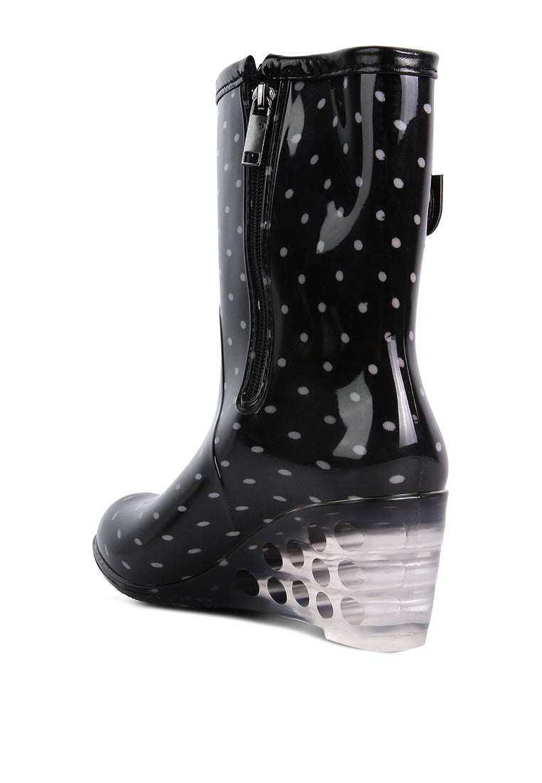 Drench Clear Wedge Rainboots featuring a clear wedge heel, side zipper, and buckle detail, perfect for stylish monsoon wear.