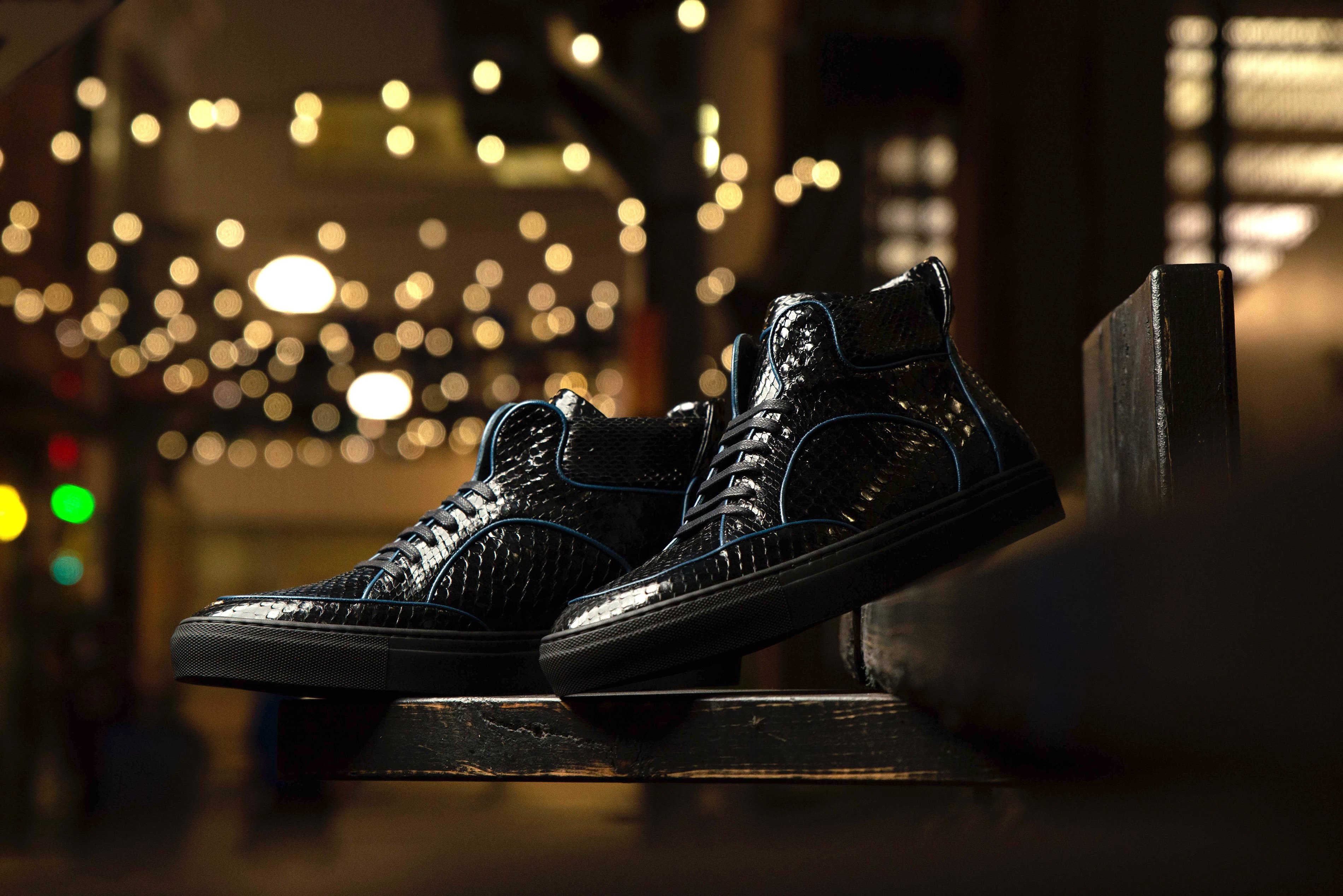 Dtown Python High Top Sneakers featuring a black python exterior and navy calf piping, showcasing a stylish high top design.