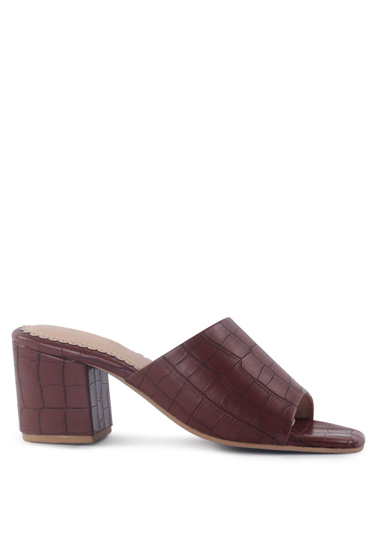 Dumpllin Croco Slip-On Block Heel Sandals featuring a stylish croc pattern and mid block heel design.