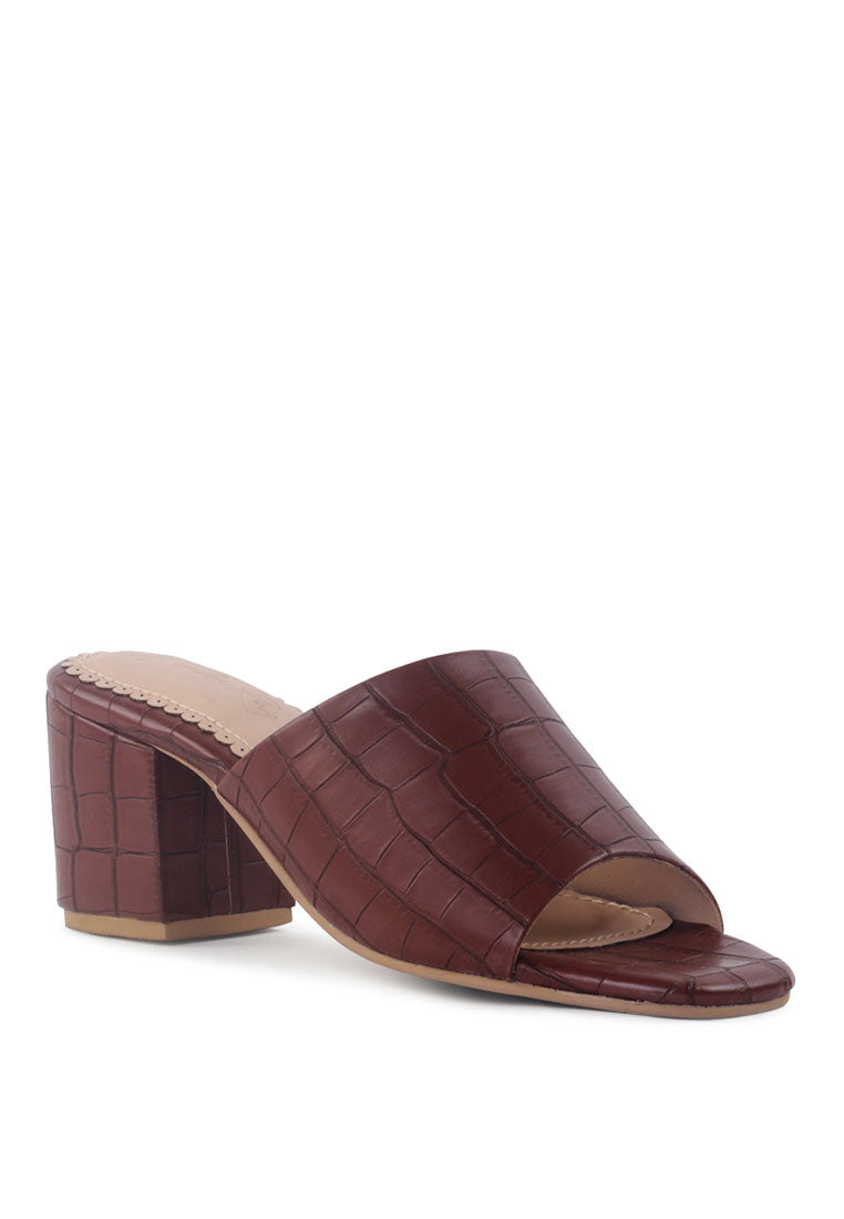 Dumpllin Croco Slip-On Block Heel Sandals featuring a stylish croc pattern and mid block heel design.