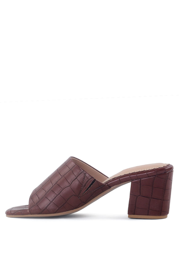 Dumpllin Croco Slip-On Block Heel Sandals featuring a stylish croc pattern and mid block heel design.