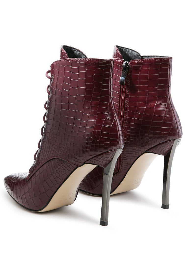 Escala Croc Stiletto Ankle Boots featuring a lace-up design and shiny stiletto heels, crafted from croc textured faux leather.