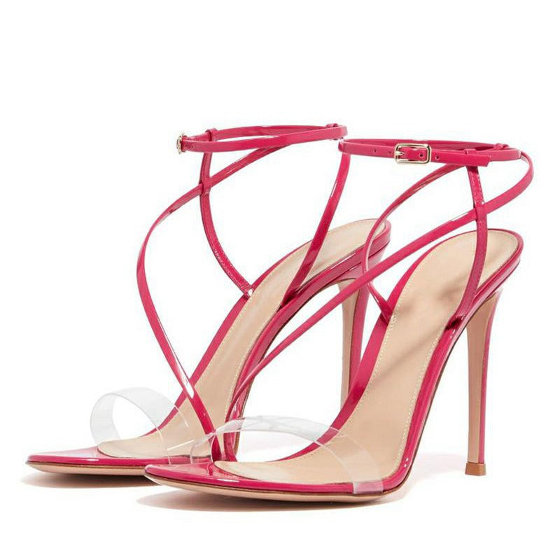 Fashion sandals featuring cross straps and thin heels, designed for women, showcasing a sleek patent leather finish.