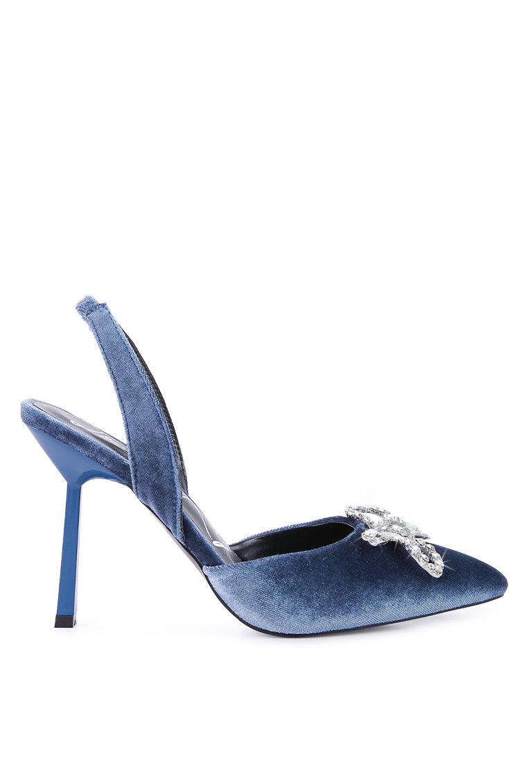 Firebird Pump high-heeled mules in luxurious velvet with a decorative diamante brooch, showcasing a closed pointed toe and elasticated slingback.