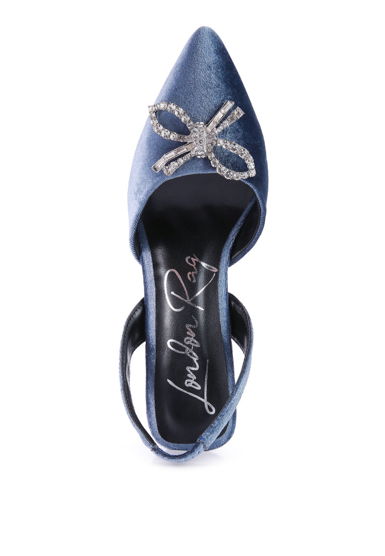 Firebird Pump high-heeled mules in luxurious velvet with a decorative diamante brooch, showcasing a closed pointed toe and elasticated slingback.