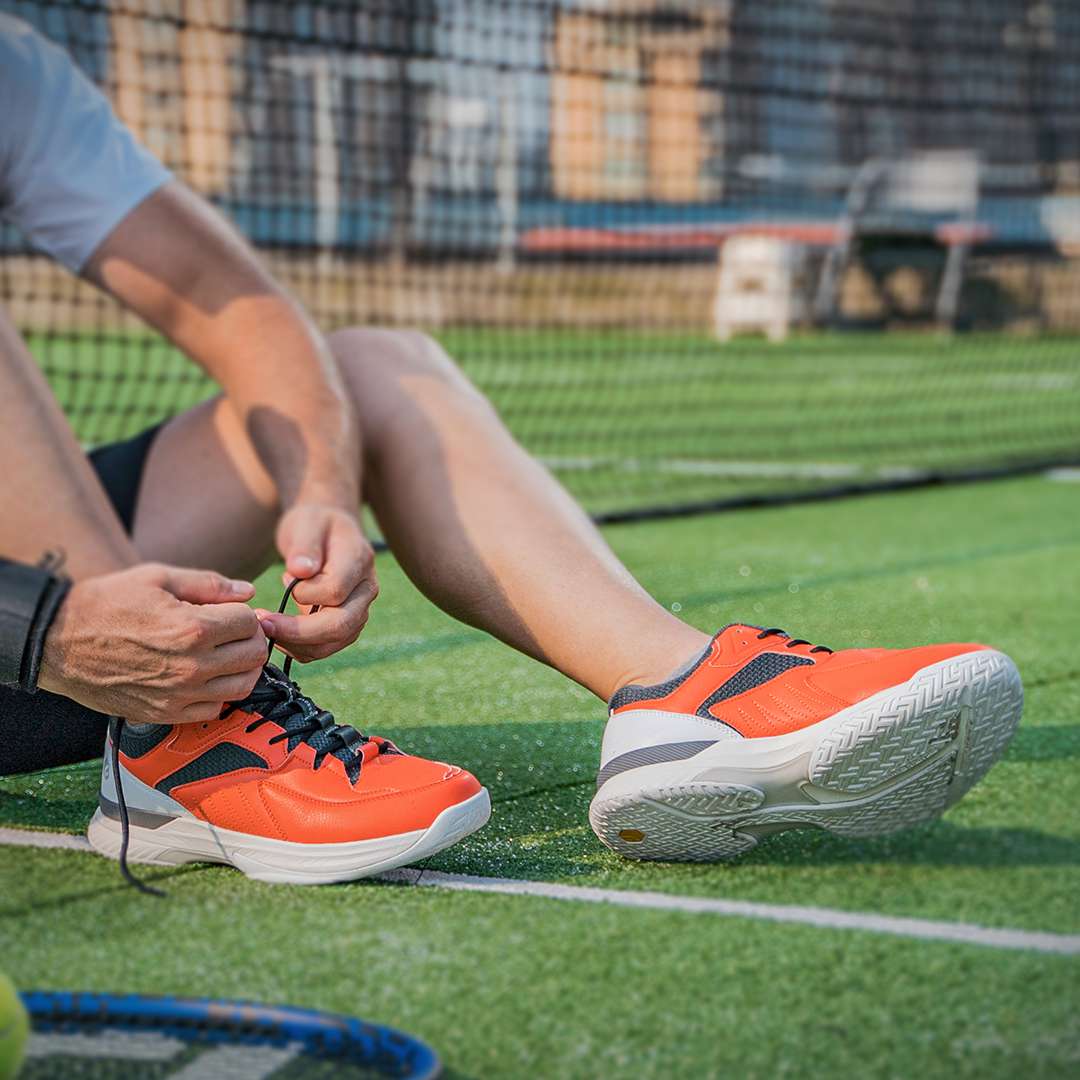 FitVille Men's Court Tennis Amadeus V1 shoes in black, white, orange, and khaki, showcasing a modern design with a wide toe box and breathable upper.