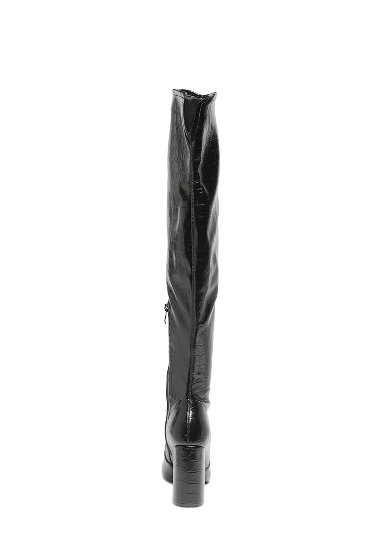 Flittle Over-The-Knee Boots featuring a stylish design with a block heel and pointed toe, made from faux leather.