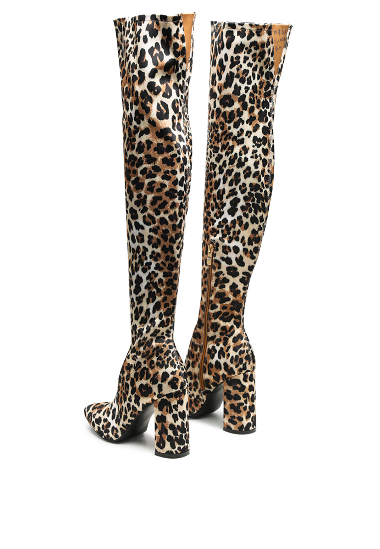 Flittle Over-The-Knee Boots featuring a stylish design with a block heel and pointed toe, made from faux leather.